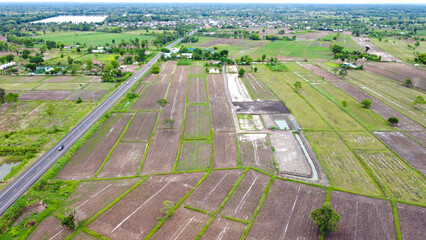 Aerial drone view of green fields and farmland.