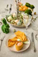 Festive table setting for Easter celebration on light background
