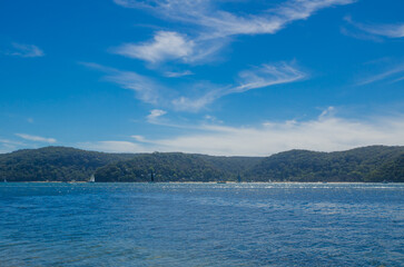 Blue sky and ocean water with mountain view at Palm beach NSW.