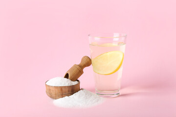 Bowl with baking soda and glass of water on pink background