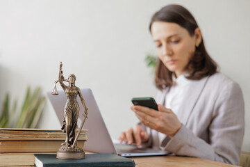 European female lawyer advises a client by phone or online. selective focus. lawyer checks contract...
