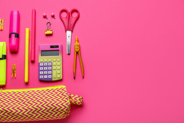 Bright pencil case with stationery supplies on pink background