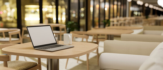 Fototapeta na wymiar Comfortable restaurant or coffee shop seating area interior design with laptop mockup