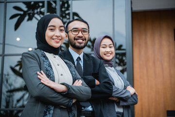 beautiful muslim businesswoman leader as she standing in front of her team smiling proudly to camera