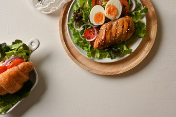 Healthy breakfast menu, A plate of salad mix with roasted chicken breast and chicken croissant.