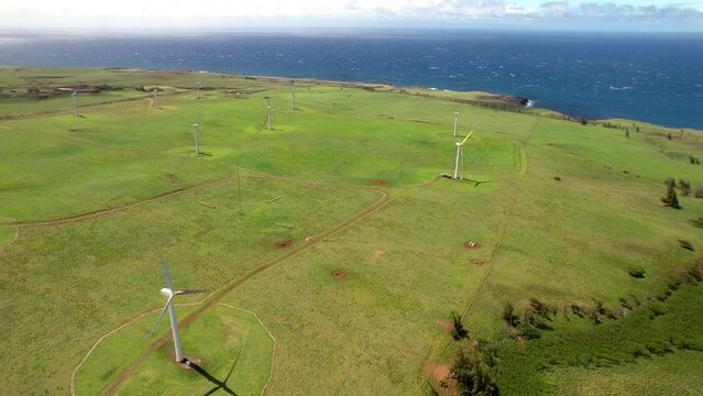 Hawi Wind Farm on Upolu Point of Hawaii's Big Island with an aerial view of the ocean and wind turbines generating clean, alternative energy