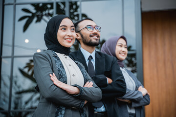 confident business muslim woman with partner standing and looking up as they are looking at their business vision