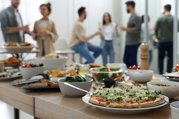 Brunch table setting with different delicious food.and blurred view of people on background