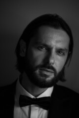 Elegant young handsome man in suite wearing glasses. Studio fashion portrait.