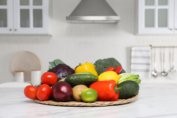 Pile of fresh ripe vegetables and fruits on table in kitchen