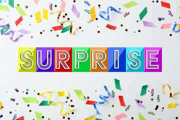 It's a surprise party. Colorful confetti and streamers on white background, top view