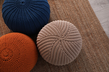 Stylish comfortable poufs on carpet, top view. Home design