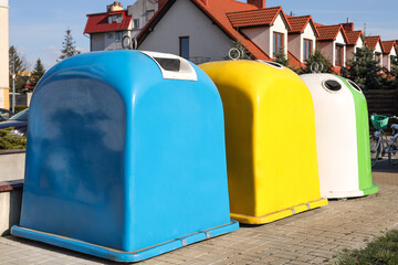 Fototapeta na wymiar Bright colorful recycling bins outdoors on sunny day