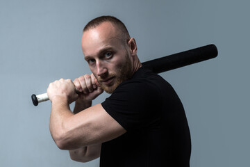 Brutal man, handsome serious male model. Guy with baseball bat for fighting. Dangerous man with...