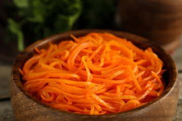 Delicious Korean carrot salad in wooden bowl, closeup