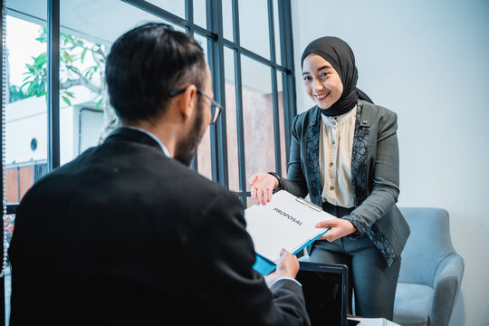 muslim woman Business adviser analyzing financial of the company giving a proposal to her partner