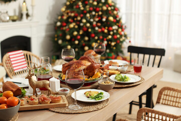 Festive dinner with delicious food and wine on table indoors. Christmas celebration