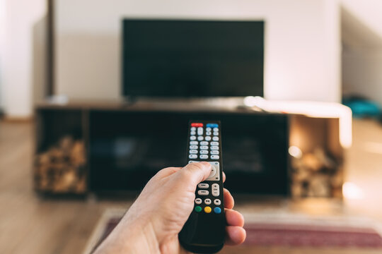 Male hand with Tv remote controller