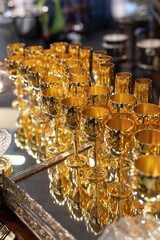 Group of Gilded Goblets arranged Neatly on a Mirrored Tray with Reflection