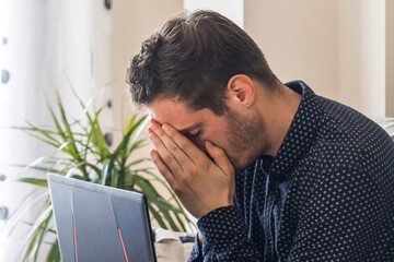 stressed and worried man with his laptop at home or in the office