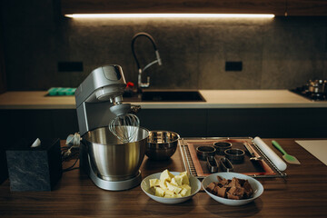 A beautiful white mixer with a metal cup stands in the modern kitchen