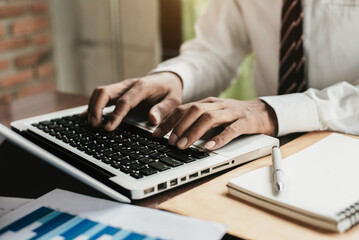 Businessman using laptop at home, Man hands typing on computer keyboard, online learning, internet marketing office workplace freelance concept.