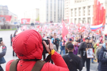 A photographer photographs a festive procession in Moscow, May 9, 2022, an immortal regiment.