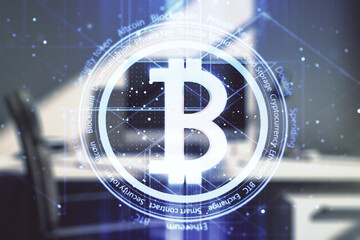 Double exposure of creative Bitcoin symbol and modern desktop with laptop on background. Cryptocurrency concept