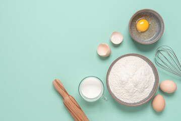 Baking ingredients on mint green background. Baking background. Top view, flat lay, copy space.
