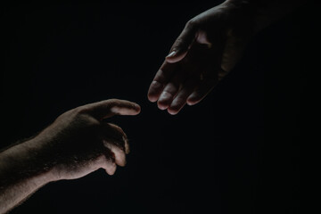 Men holding hands isolated on black. Connection and human relations. Male hands rescue. Friendly...