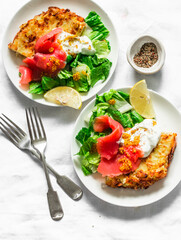 Potato tortilla frittata with natural greek yogurt, smoked salmon and green salad on a light background, top view. Delicious breakfast, appetizer, tapas