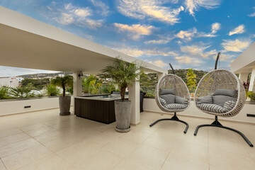 Two egg chair swing on a luxury terrace