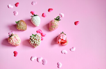 strawberries in chocolate with scattered hearts on a pink background. Sweet gift for Valentine's Day