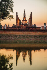 Sunset at Wat Mahathat buddha and temple in Sukhothai Historical Park