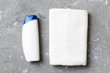 Cosmetic shampoo bottle mockup with towels on a colored table. Bathroom background, toilet accessories for hand and body care