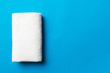 Top view of white towels with copy space on colored background