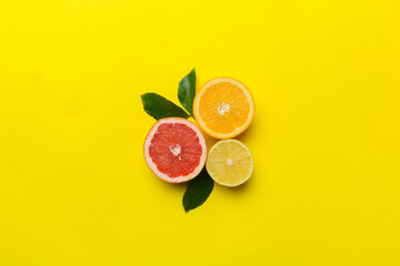 Fruit background. Colorful fresh fruits on colored table. Orange, lemon, grapefruit Space for text...