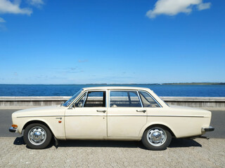 Obraz na płótnie Canvas Classic car at seaside, summer and blue sky - stock photo