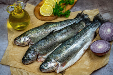Three raw trout ready to be cooked.