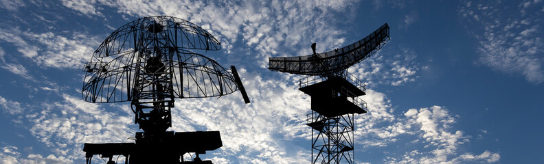 Air defense radars of military mobile anti aircraft systems, modern army industry on background beautiful clouds and sky, Russia