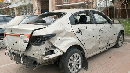 Irpin, Ukraine, April 2022. Damaged car after being hit by shell fragments. Consequences of the war...
