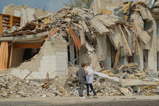Boys at destroyed school in the Ukrainian city. Russian aggression concept