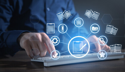 Businessman using a computer keyboard. Online documentation database