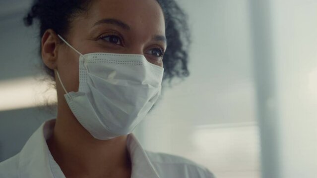 Portrait african nurse talking to interlocutor in clinic. Doctor making checkup.