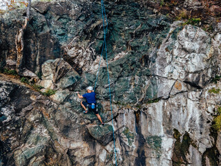 Able man, loving his hobbie, enjoying a good day, climbing.