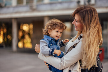 Mother and son spend the day outdoor, in a hug.