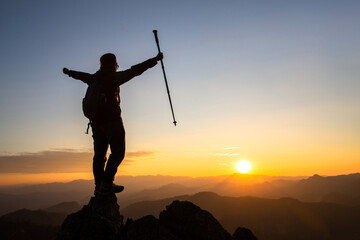 Fototapeta na wymiar Silhouette of a woman standing on a mountain concept of leadership, success, hiking.