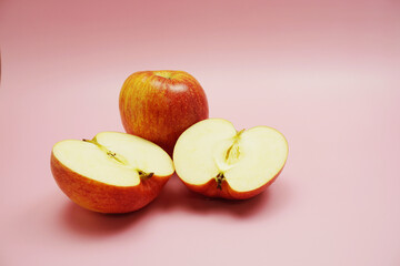 Apple cut half slices with space copy on pink background