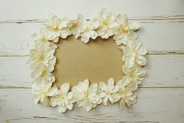 Empty paper craft with flower bouquet Top view on wooden background