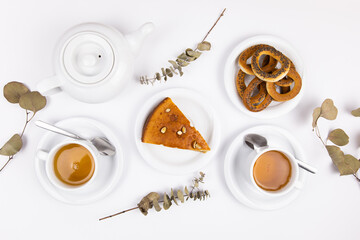 white tea set with teapot tea and saucers and pie for breakfast